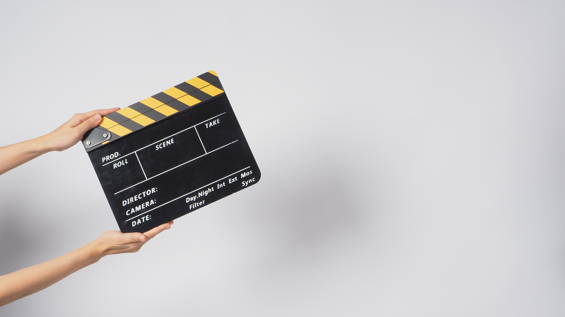 Hand Holding a Clapperboard on White Background Copy Space